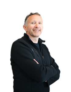 A photo of Norman Crowley. Norman is wearing a black zip jumper.