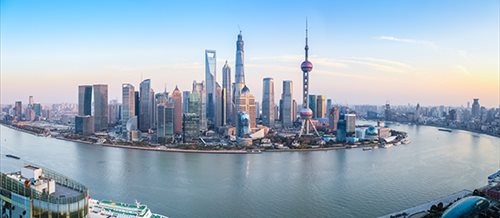 An image of a city with a large body of water in front of it.