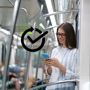 An image of a woman on a bus smiling at her phone. Overlaid on the image is a tick in a circle.