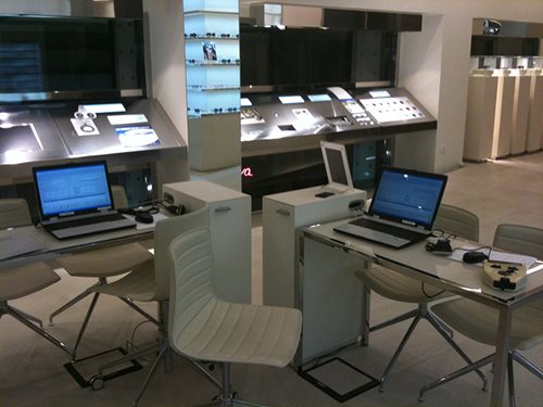 A photo of a lab office with two desks, chairs and laptops.