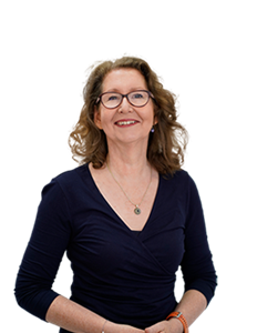 A photo of Josephine Austin. Josephine has light brown curly hair and is wearing a navy dress along with brown glasses.